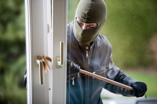 man burglarizing a home